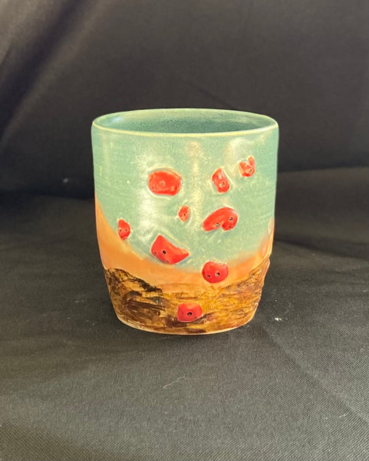 Rock climbing mug, red holds with bolt holes, rocky landscape with blue and pink sunset.  boulder mug hand carved, handmade, pinch grip handle