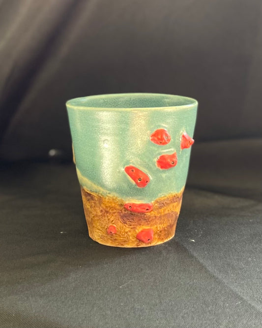 Rock climbing mug, red holds with bolt holes, rocky landscape with blue skies.  boulder mug hand carved, handmade, pinch grip handle