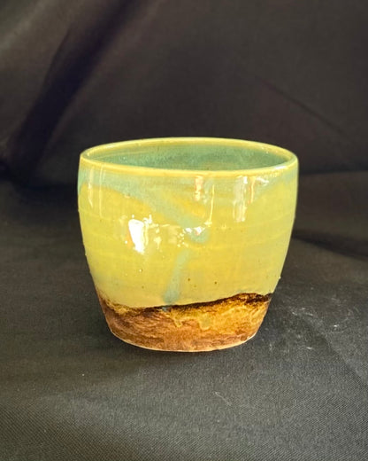 yunomi ceramic tea cup, hand textured rugged rocky mountain landscape, iron oxide wash, celadon blue green sky, wabi sabi.