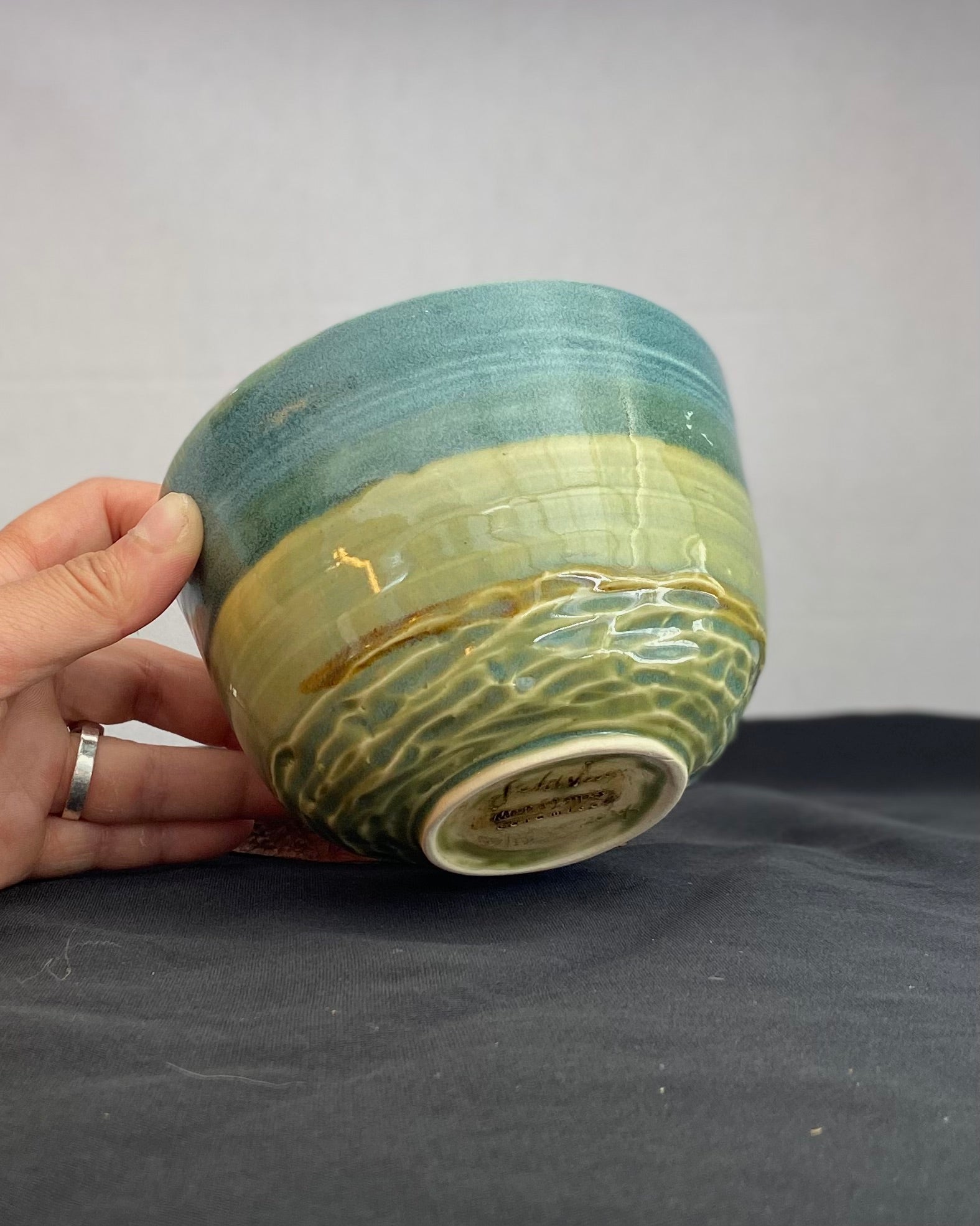 Handmade ceramic ocean bowl with hand-carved ripple texture, and antique blue satin and celadon froth gloss glaze