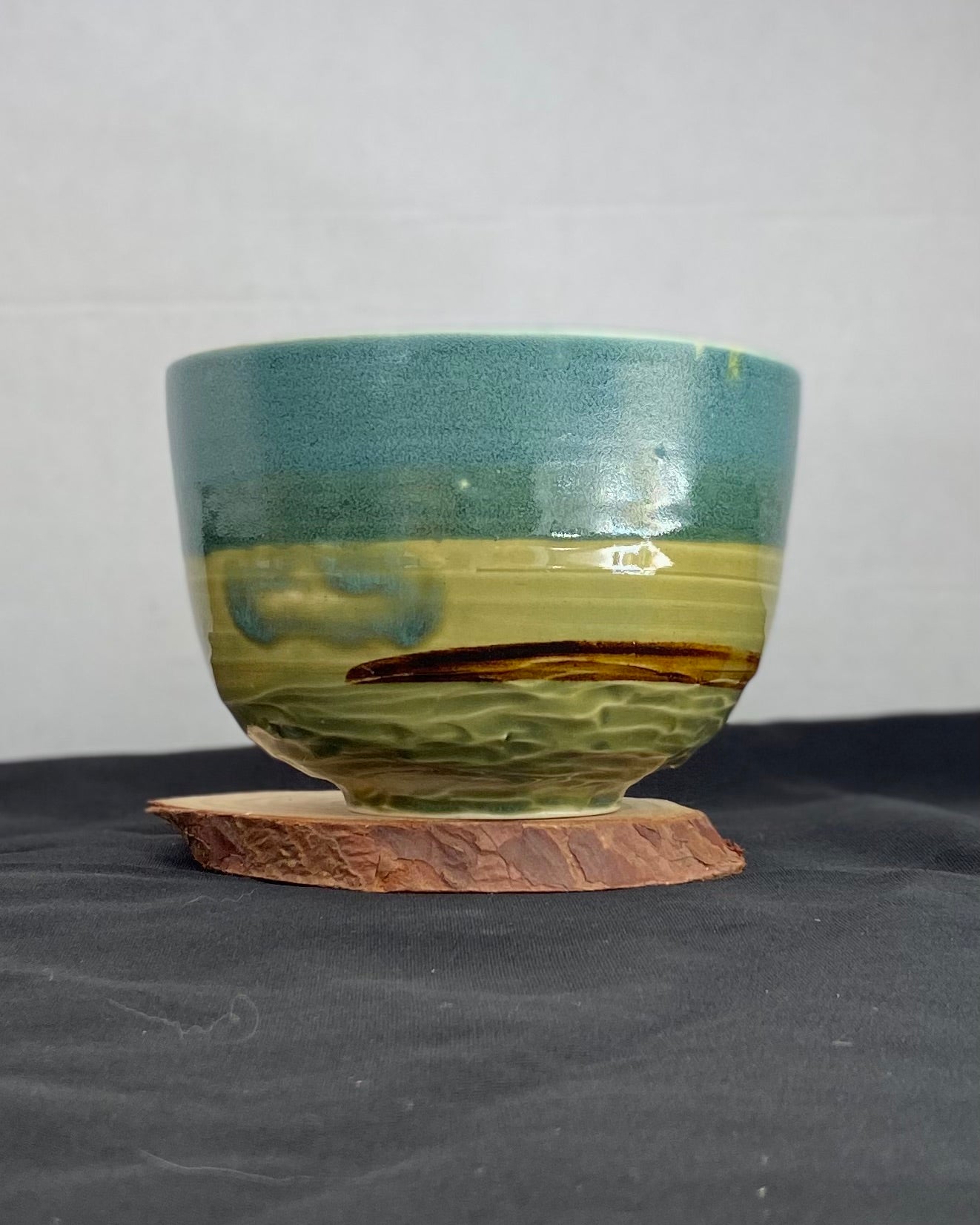 Handmade ceramic ocean bowl with hand-carved ripple texture, and antique blue satin and celadon froth gloss glaze