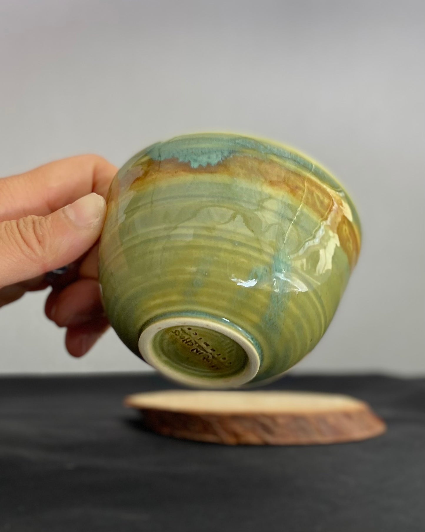 Handcrafted ceramic bowl with smooth celadon glaze and cacao shino detail