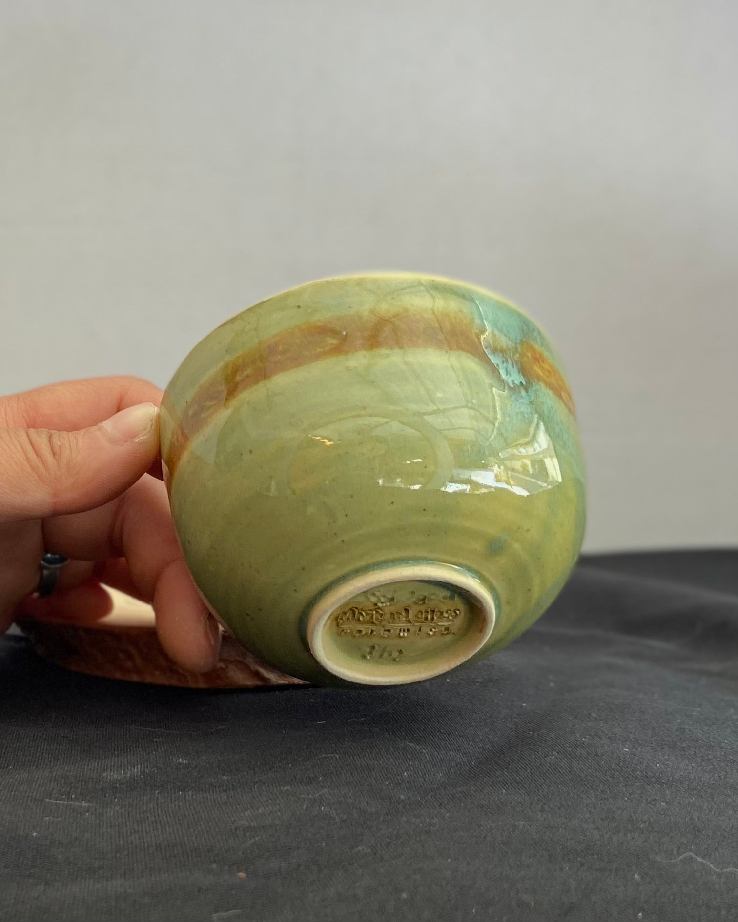 Handcrafted ceramic bowl with smooth celadon glaze and cacao shino detail