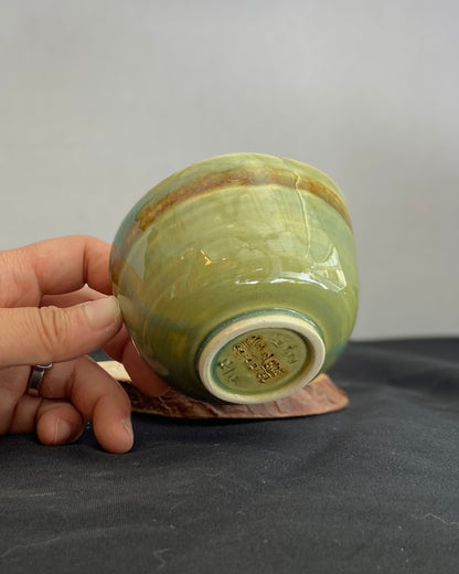 Handcrafted ceramic bowl with smooth celadon glaze and cacao shino detail