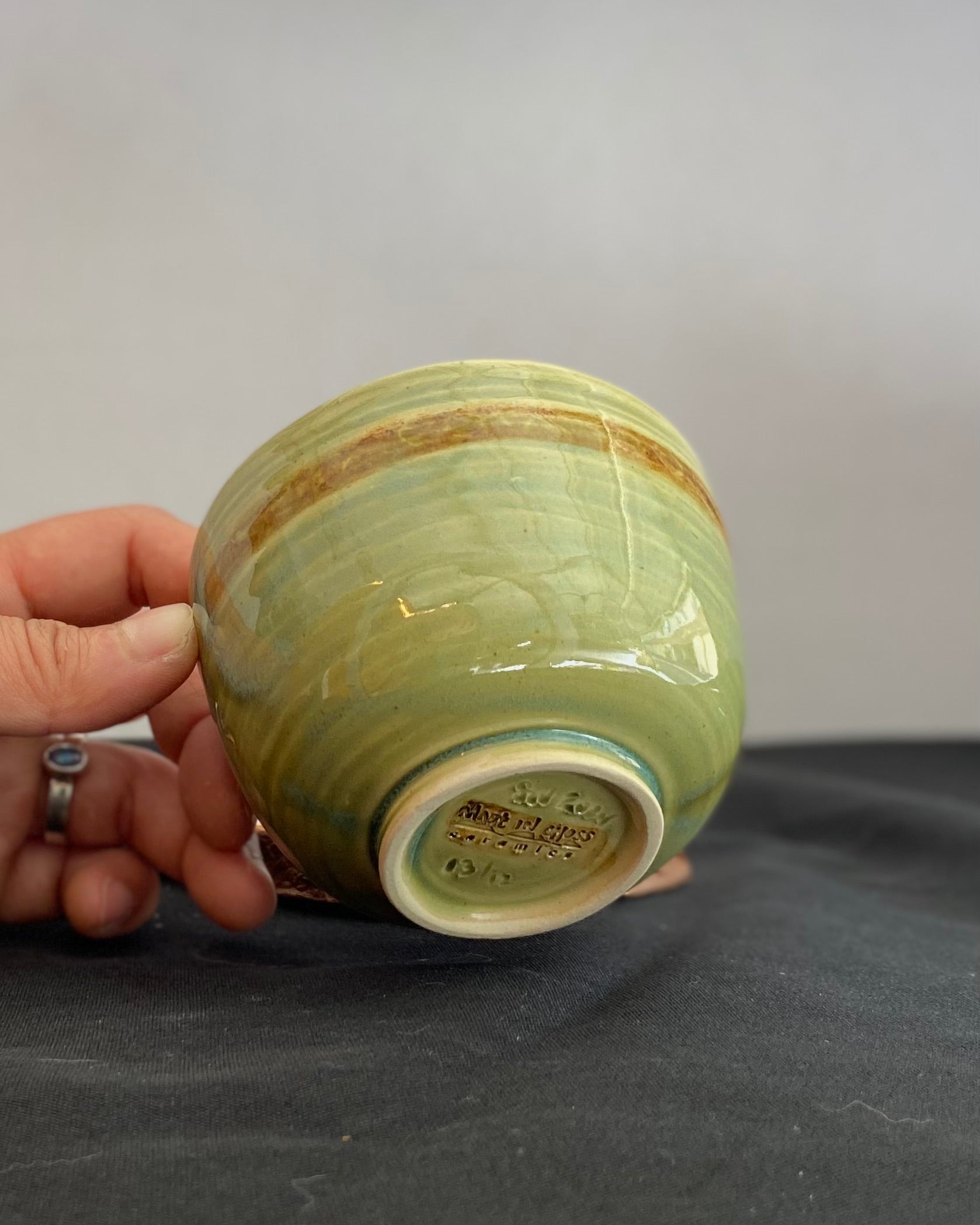 Handcrafted ceramic bowl with smooth celadon glaze and cacao shino detail