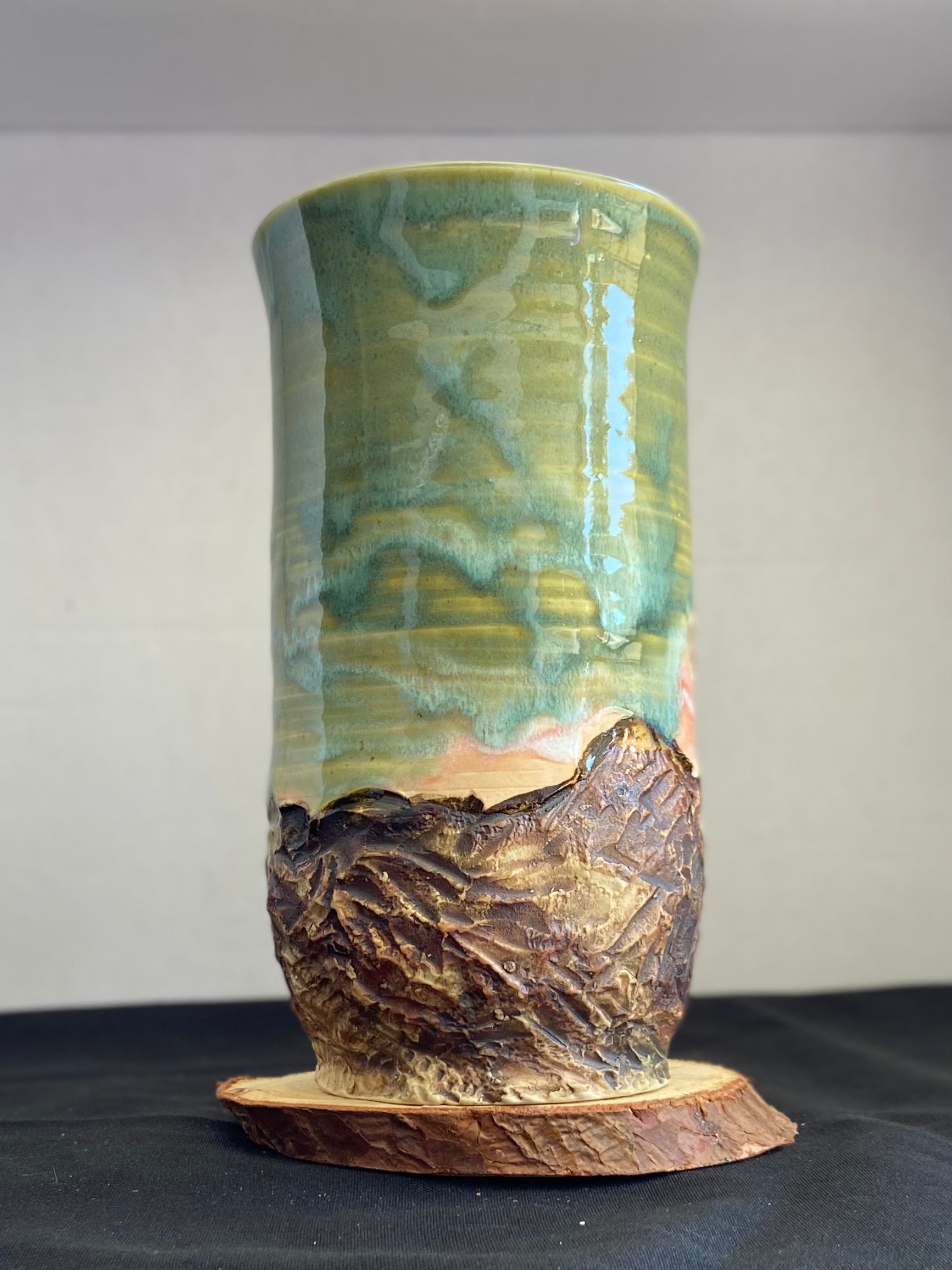 Handcrafted vase with two Joshua trees etched, celadon and pink sunset glaze, and hand-carved landscape. Unique ceramic vase inspired by nature, perfect for displaying flowers or as a decorative piece. Artisan quality, wabi sabi design, and nature-inspired aesthetic