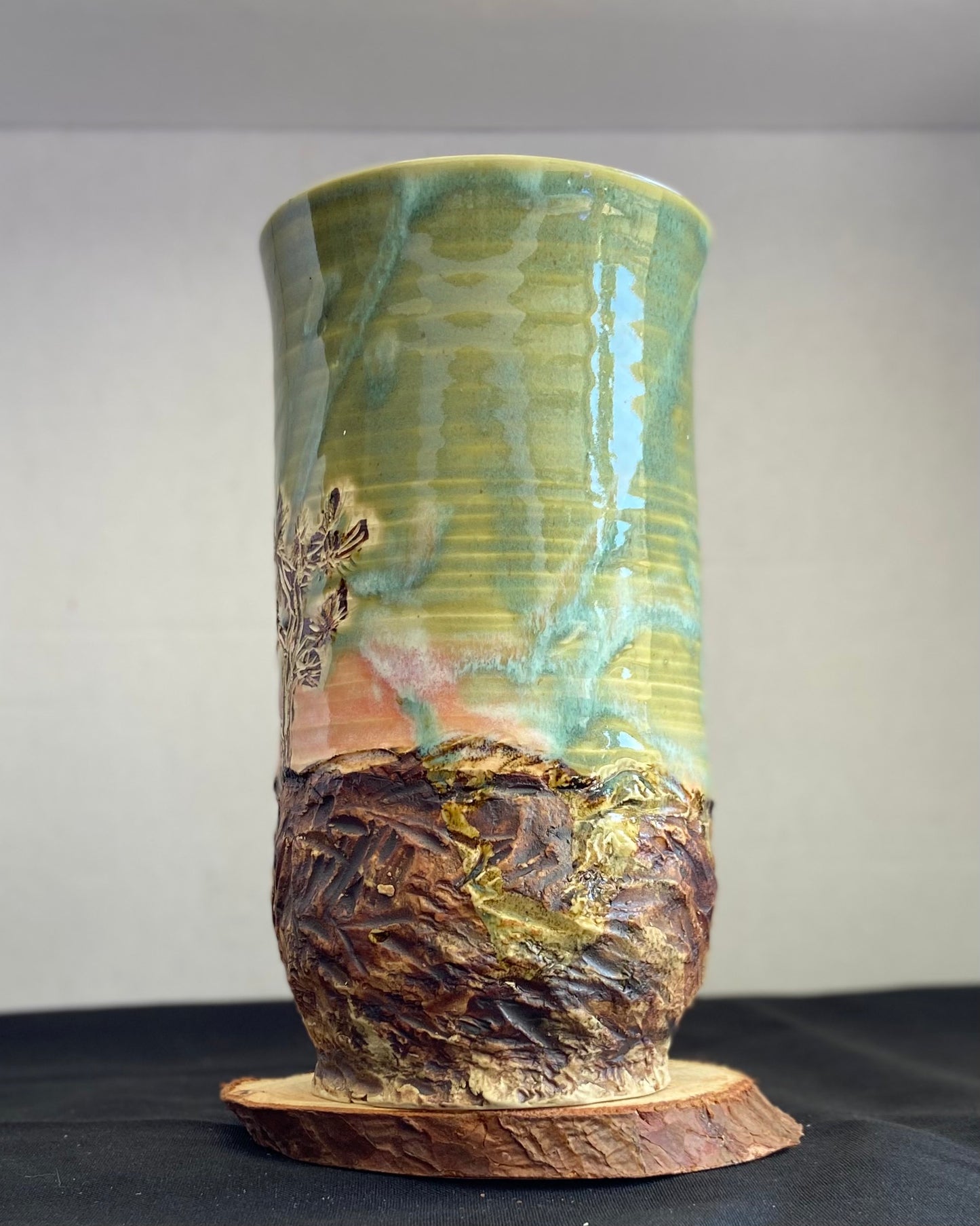 Handcrafted vase with two Joshua trees etched, celadon and pink sunset glaze, and hand-carved landscape. Unique ceramic vase inspired by nature, perfect for displaying flowers or as a decorative piece. Artisan quality, wabi sabi design, and nature-inspired aesthetic