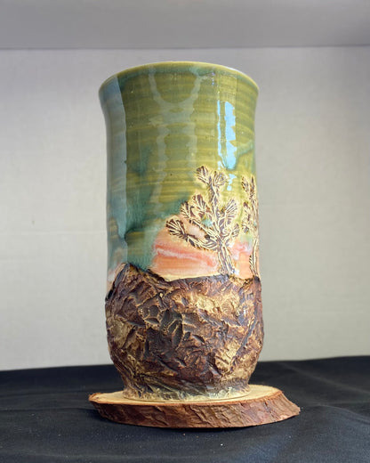 Handcrafted vase with two Joshua trees etched, celadon and pink sunset glaze, and hand-carved landscape. Unique ceramic vase inspired by nature, perfect for displaying flowers or as a decorative piece. Artisan quality, wabi sabi design, and nature-inspired aesthetic