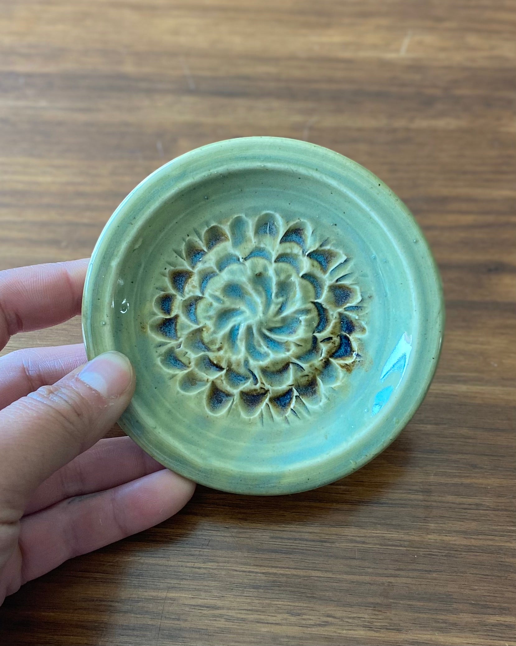 hand crafted, hand carved flower dish, celadon blue glaze with iron oxide accent.