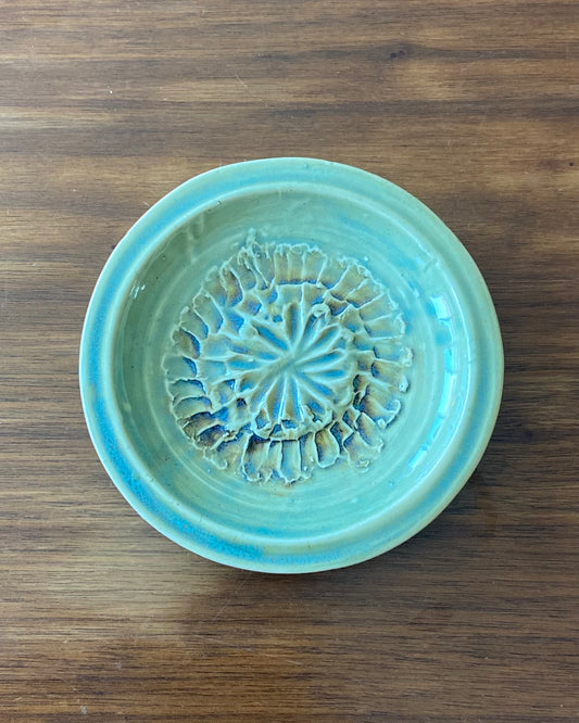 hand crafted, hand carved flower dish, celadon blue glaze with iron oxide accent.