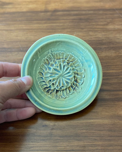 hand crafted, hand carved flower dish, celadon blue glaze with iron oxide accent.